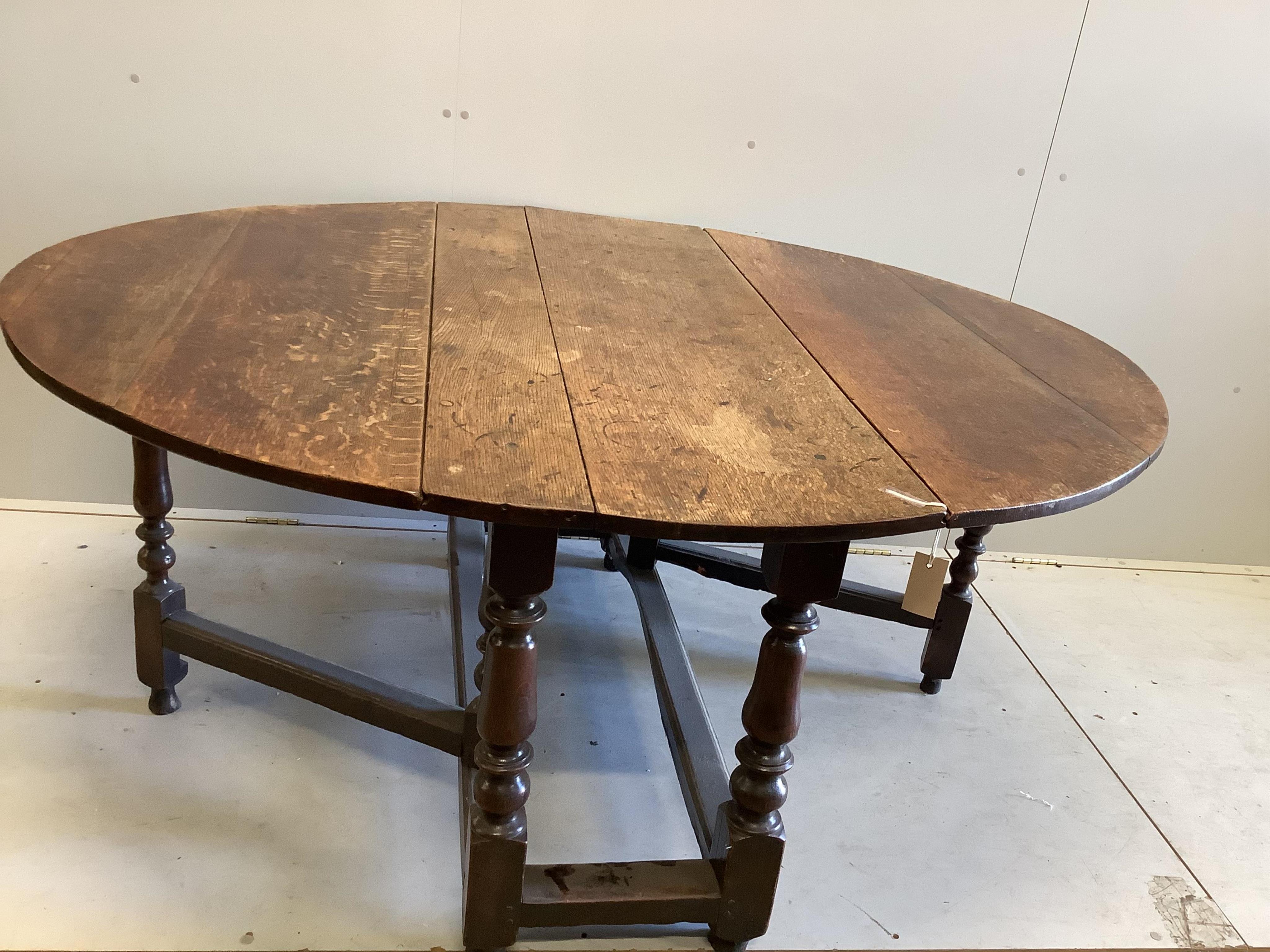 An 18th century oak gateleg table, width 135cm, depth 55cm, height 73cm. Condition - poor to fair